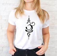 a woman wearing a white t - shirt with black designs on it