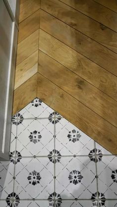 the corner of a bathroom with wood flooring