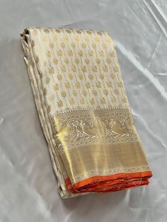 Bridal Collection White Color Pure Kanchipuram Silk Saree | Indian Traditional Ethnic Saree | Wedding or Party Wear Saree | Handwoven Gift Saree for Her Product Details : Saree Type : Pure Kanchipuram Silk Saree Golden Zari, Silk Mark Certified Blouse Piece : Yes (Un-Stitched) Saree Length : 5.5 Meters Blouse Piece Length : 80 cm Saree Weight : 0.9 kg Saree Fabric : Pure Kanchipuram Silk  Color : As shown in the picture Work : weaving Pattern : designer Occasion: Party Wear, Formal Wear, Festiva Traditional Pre-draped Cream Saree, Semi-stitched Paithani Silk Saree For Wedding, White Tussar Silk Pre-draped Saree For Diwali, Gold Pre-draped Saree With Traditional Patterns For Festivals, Traditional Off White Chanderi Pre-draped Saree, Traditional Ceremonial Pre-draped Saree With Cutdana, Festive Off White Silk Saree, Off White Traditional Wear For Wedding And Navratri, Festive Art Silk Cream Blouse Piece