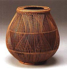 a brown vase sitting on top of a white table