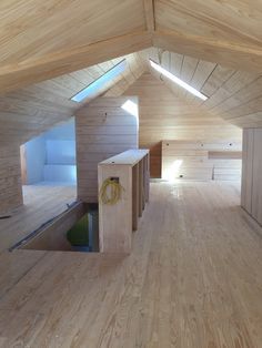 an empty room with wooden walls and floors is seen in this image from the inside