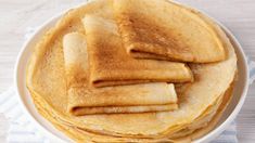 a stack of pancakes sitting on top of a white plate