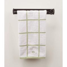 a white and green towel hanging on a wall