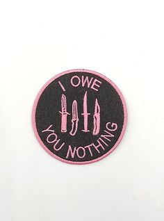 a pink and black patch with the words i love you nothing written in white on it