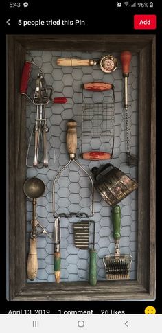 an old framed photo with tools and other things on it's display shelf in a frame