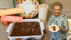 an older woman holding a plate with food on it next to other plates and dishes