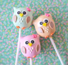 three cake pops decorated like owls on a table