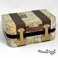 a small suitcase with brown straps is on the white surface and has money all over it