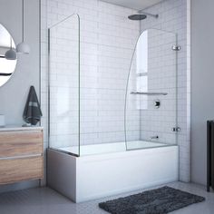 a white tiled bathroom with a walk in shower