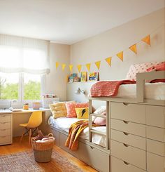 a child's bedroom with yellow and orange decor