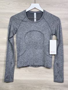 Lululemon Swiftly Tech Long Sleeve 2.0 Race Size 4 SLTE/WHT Slate White 75099 040323CR1 Condition is New With Tags. Shipped with USPS. Will combine shipping on multiple purchases and refund any shipping overage on orders shipped within the US (Not available for Ebay International Shipping Orders). Lululemon Long Sleeve Breathable Top, Lululemon Sportswear Tops For Light Sports, Lululemon Activewear With Thumbholes For Gym, Functional Lululemon Activewear With Thumbholes, Lululemon Clothes, Tech Outfit, Anna Claire, Lululemon Swiftly Tech Long Sleeve, Swiftly Tech Long Sleeve