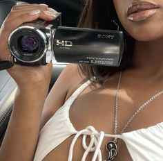 a woman holding a camera up to her face