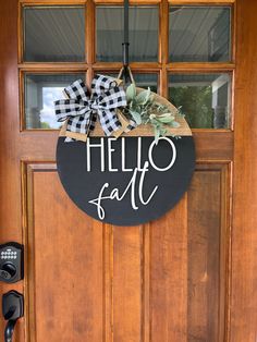 a wooden door with a sign that says hello fall