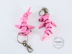 two key chains with pink plastic animals on them