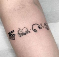 a tattoo with headphones and books on it