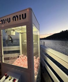 a machine that is on the side of a boat in the water with some food inside it