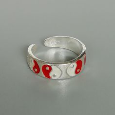 A sterling silver toe ring enameled with a red and white yin yang design. 5mm wide. This is an open ended toe ring and can be adjusted to fit most feet. These toe rings are made of 925 hypoallergenic sterling silver. Please note this price is for ONE toe ring only. Sent in a gift box. I can include a personal message from you if needed You are welcome to contact me at... bhavnakwintra1956@gmail.com For more beautiful pieces from my shop, please browse 👇 TOE RINGS: https://www.etsy.com/your/shop Adjustable White Toe Rings For Gift, Adjustable White Toe Rings As Gift, White Sterling Silver Toe Rings For Gift, White Sterling Silver Toe Rings As Gift, Sterling Silver White Toe Rings As Gift, Yin Yang Designs, Sterling Silver Toe Rings, Silver Toe Rings, Jewelry Minimalist