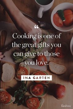 someone is cooking on the table with their hands over some breads and tomatoes in bowls