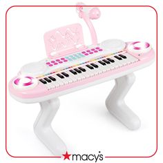 a pink and white musical toy piano with music lights on it's legs,