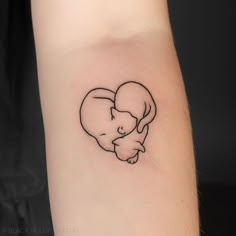 a small elephant tattoo on the arm