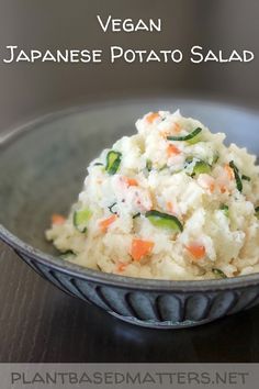 a bowl filled with rice and vegetables on top of a table