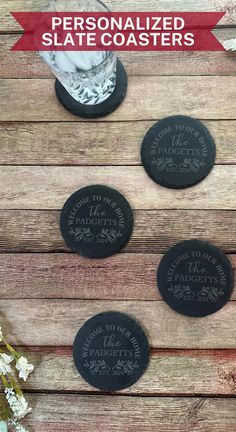 personalized slate coasters on a wooden table