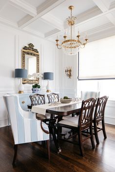 a dining room table with chairs and a chandelier