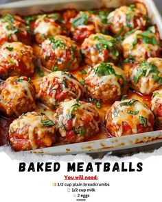 baked meatballs with tomato sauce and parsley in a baking pan