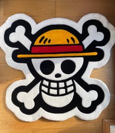 a skull and crossbones rug with a yellow hat on it's head