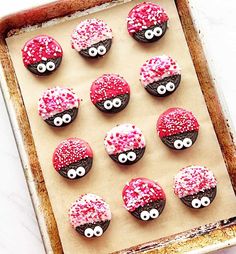 cupcakes decorated with red and white sprinkles in the shape of eyes