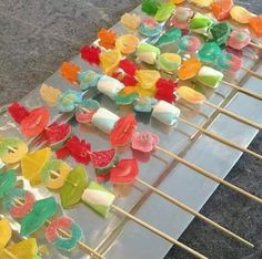 many different colored candies are on sticks