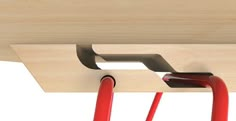 a close up of a wooden shelf with red handles