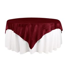 a red and white table cloth on top of a round table