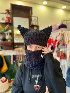 "Product Details; Cat Balaclava Beanie -Our mask is all hand knitted. This balaclava has 2 sizes for daily use  and for with helmet use.  All Designs are unisex We have offered 48 colors optioned. Please write the color code when you place order. -Free Shipping to Worldwide ✈️ -İt is completely hand knitted  -İt is knitted high quality  acrylic  yarn 🧶 -Some of our products are ready to ship and ship within 1-2 days. Some are made to order and will be ready to ship in 1-2 weeks at the latest. -You can customize pattern,color and size of our  all products as you wish. Please contact us via message for any all your requests.  SİZE AND FİT I made it according to the standard hat size but since it's crocheted flexible so it can fit more than one size.  If you have any further questions, pleas Black Knitted Winter Bonnet, Winter Knitted Black Bonnet, Winter Black Knitted Bonnet, Knitted One-size Hooded Balaclava, Novelty Warm Beanie For Winter, Black Novelty Beanie For Winter, Crochet Full Face Balaclava For Winter, Winter Cosplay Beanie Hat, Black Crochet Beanie For Winter