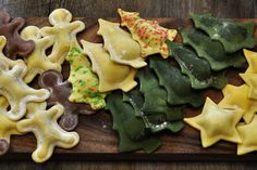 some cookies are on a wooden board with green and yellow icing, one is shaped like stars