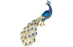 a peacock brooch with blue and green stones on it's tail, sitting in front of a white background