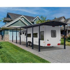 an rv parked in front of a house with a carport attached to the side