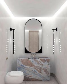 a white bathroom with marble counter top and mirror above the sink, along with lights on either side of the wall