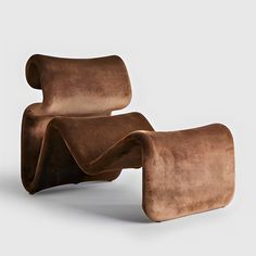 an unusual chair and ottoman made out of suede leather, with the seat folded back