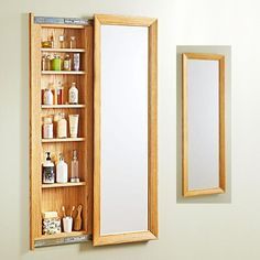 a wooden medicine cabinet with mirrors and shelves