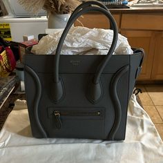 Hello! I Am Selling My Like New Celine Micro Luggage In The Beautiful Kohl Grey Color With Drummed Calfskin. I’ve Worn It Less Than A Handful Of Times. The Only Mark Is A Bit Of Rubbed Leather On The Inside As Photographed. It Comes With The Dust Bag, Tags, Receipt From Selfridges In London Where I Purchased It, And Bag Organizer. This Is Such A Beautiful Bag That Is Ready For A New Owner. All Of My Items Are 100% Authentic With Original Receipts. Poshmark Will Also Authenticate. Base Length: 10 Celine Micro Luggage, Celine Micro, Bag Organizer, Celine Bags, Bag Organization, Grey Color, Beautiful Bags, Bag Tags, Calf Skin