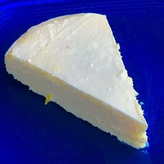 a piece of cheese sitting on top of a blue plate