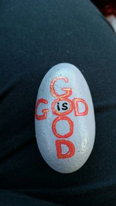 a rock with the word god is painted on it