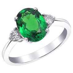 Experience the captivating allure of natural tsavorite with this exquisite 18K white gold ring. Complemented by sparkling diamonds, this piece showcases exceptional craftsmanship and the vibrant beauty of these precious gemstones. Perfect for adding a touch of sophistication to any jewelry collection, this ring is a timeless treasure. Center Stone: Natural Tsavorite Quantity & Weight: This ring features one stunning tsavorite with a total weight of 2.13 carats, making it the striking focal point White Gold Diamond Rings, Modern Ring, Natural Blue Sapphire, White Gold Ring, Three Stone Rings, Sapphire Gemstone, Diamond Sizes, Belleza Natural, Precious Gemstones