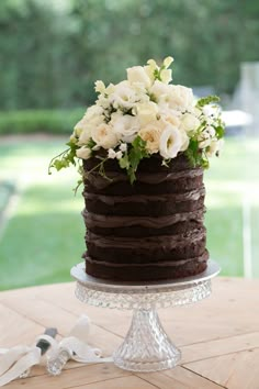 a chocolate cake with white flowers on top