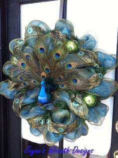 a peacock wreath is hanging on the front door