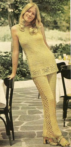 the woman is posing in her crocheted dress