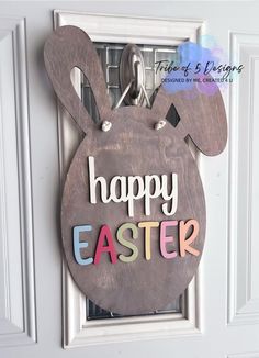 a door hanger with the words happy easter on it and an image of a bunny's head