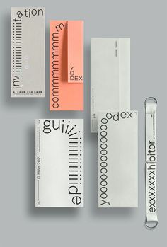 an assortment of different types of stationery and paper clips on a gray background with the same type of stationery attached to them