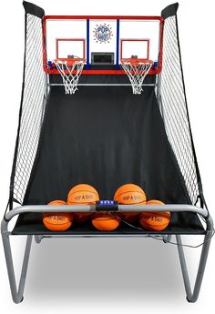 three basketballs sitting in front of a net with four orange balls on it's sides